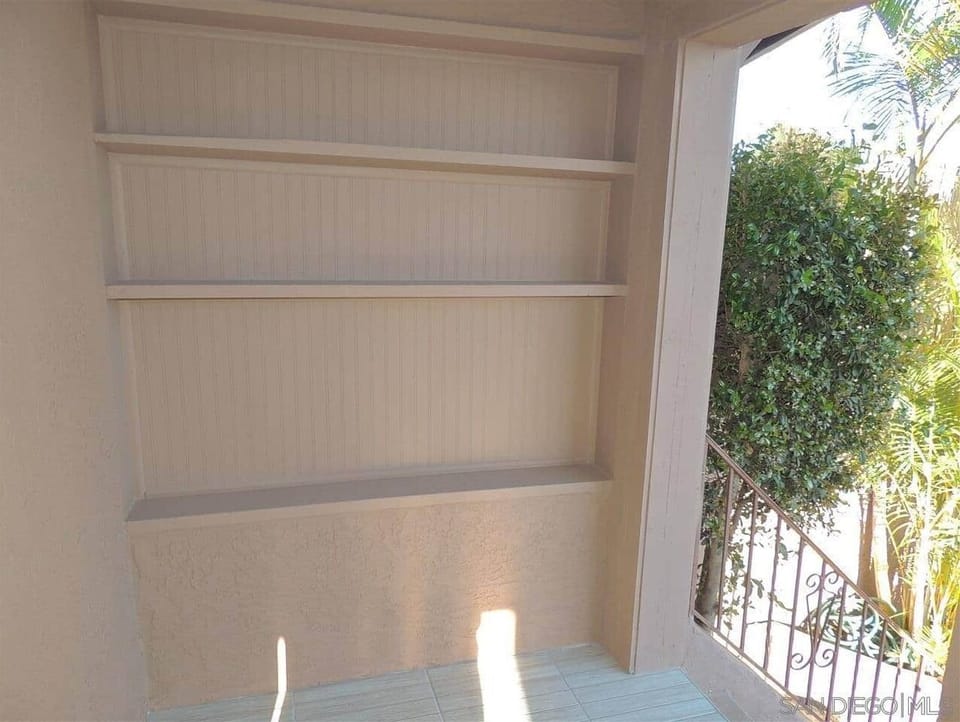 Front covered patio at top of stairs to front door.