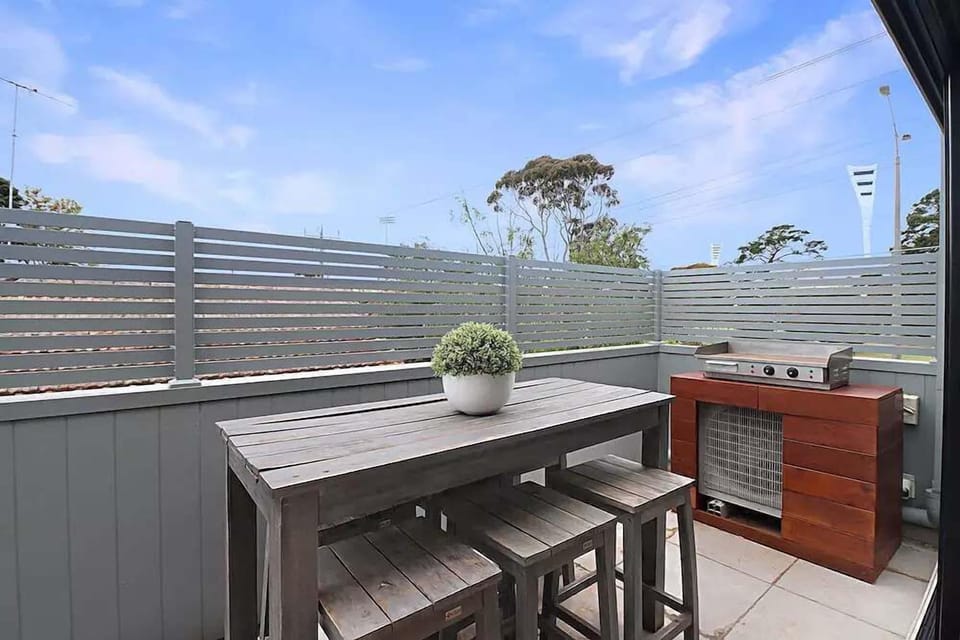 Outdoor space with furniture and BBQ.