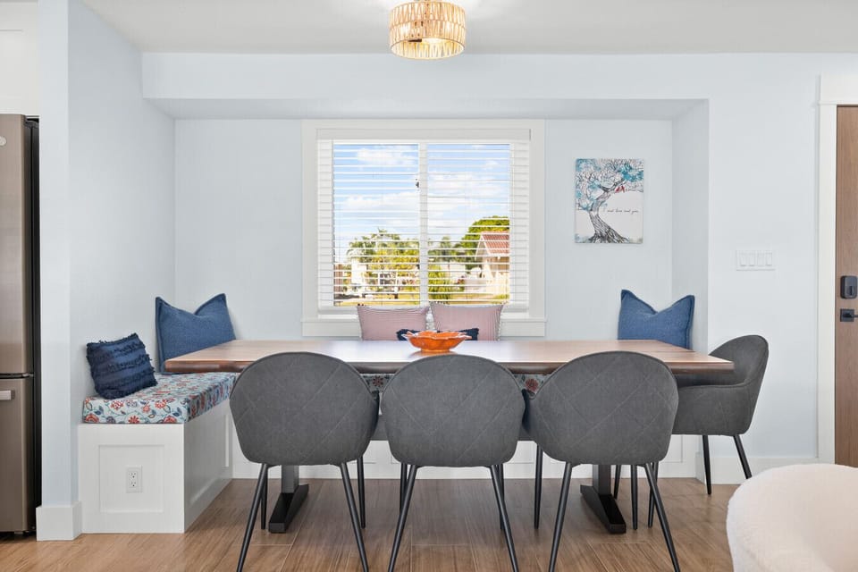 Bright dining nook with custom bench seating and canal views — the perfect spot for family meals or morning coffee.
