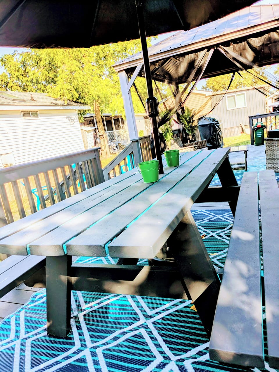 Exterior: Deck with Picnic bench that seats over 8 people under a large umbrella
