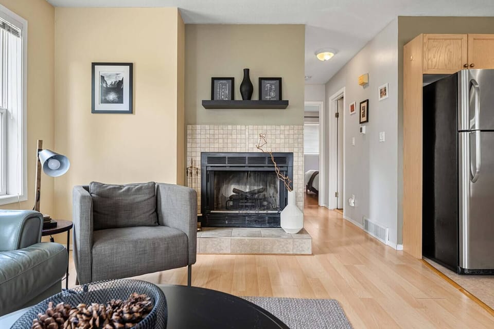 Main floor living room with cozy seating options, Smart TV, and an electric fireplace.