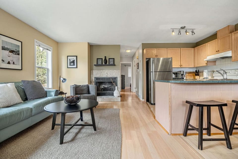 Main floor living room with cozy seating options, Smart TV, and an electric fireplace.