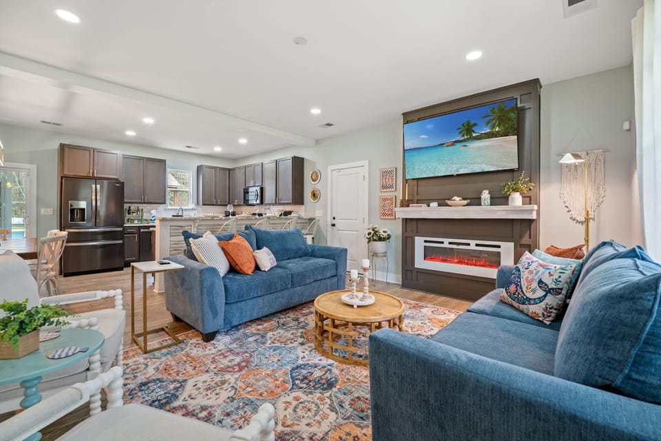 Living Room View from the Entryway - Open Concept Floor Plan, an Electric Fireplace, Large Smart TV & Lots of Lounge Space