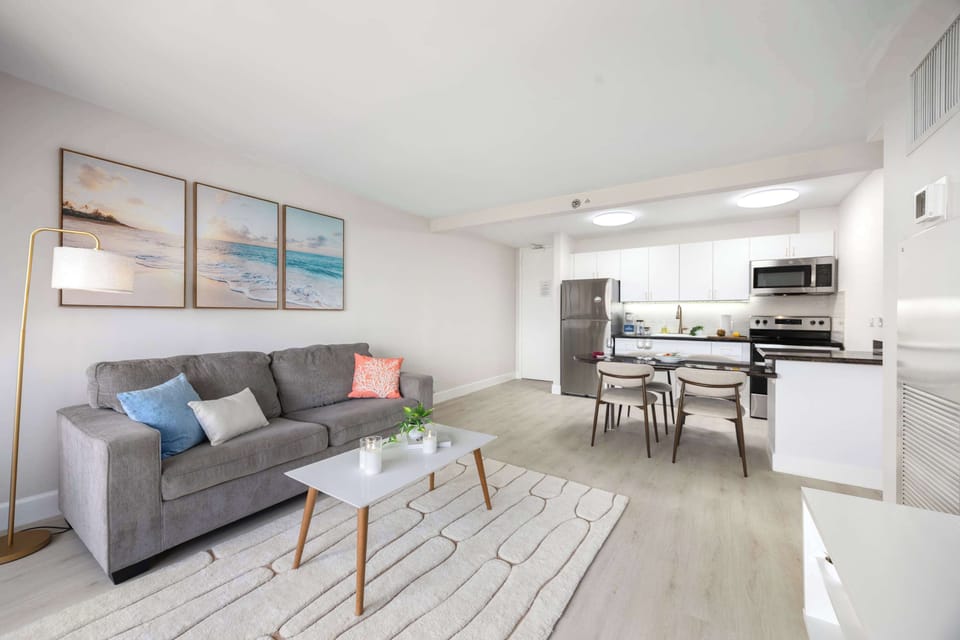 Relax in your spacious, light-filled living area that seamlessly opens to a modern kitchen and dining space.