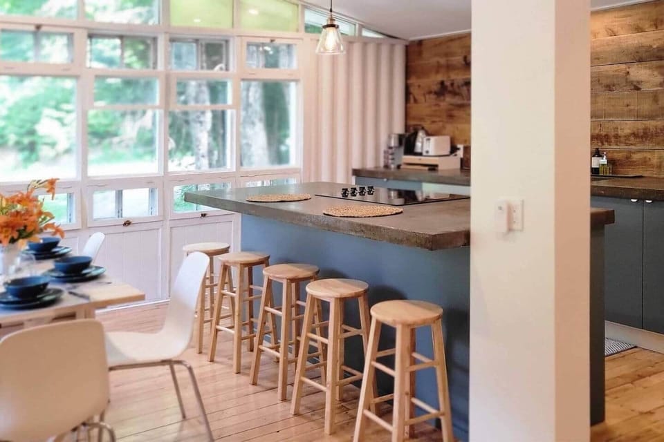 Fully equipped kitchen with seating at the table and at the bar.