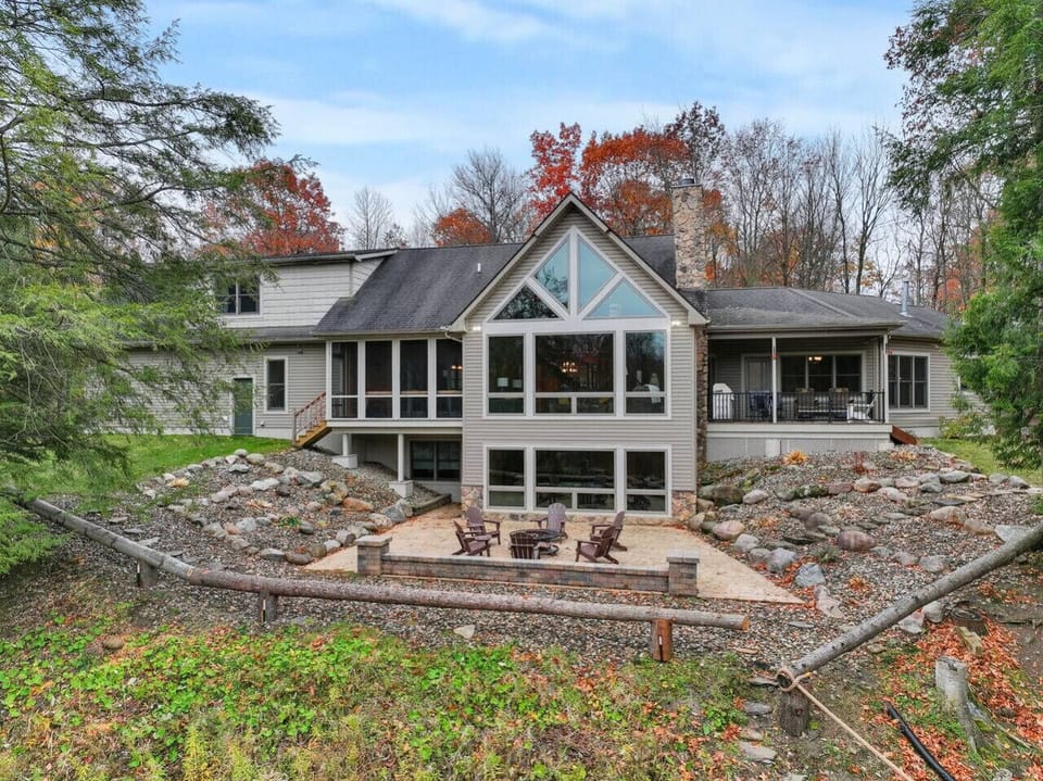 Backyard oasis with gathering areas, fire pit & scenic forest backdrop