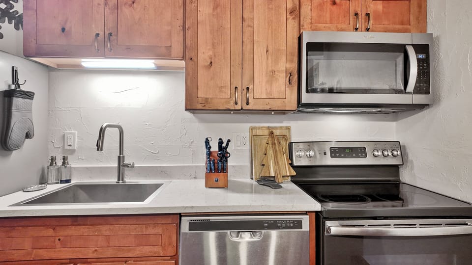 Chef’s Kitchen: Modern appliances and rustic wood cabinetry for home meals.