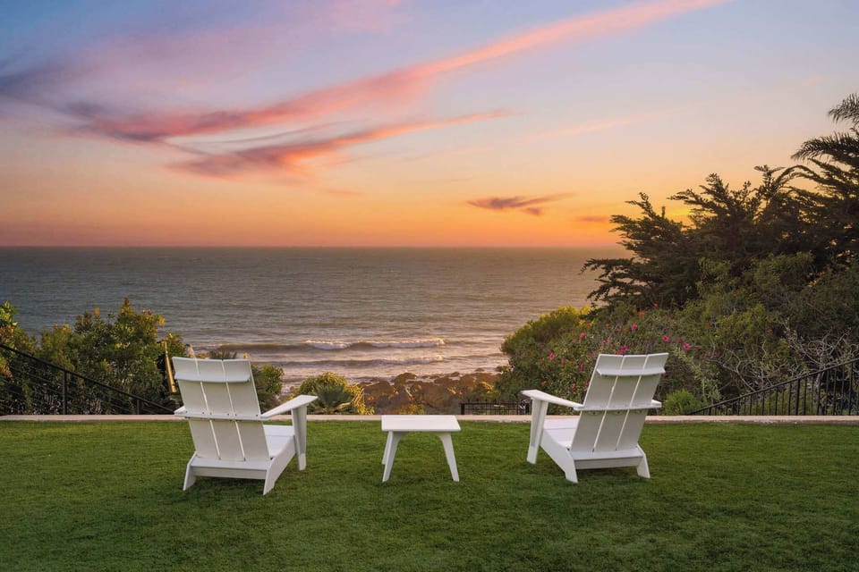  Adirondack chairs overlooking Malibu’s rocky coastline.