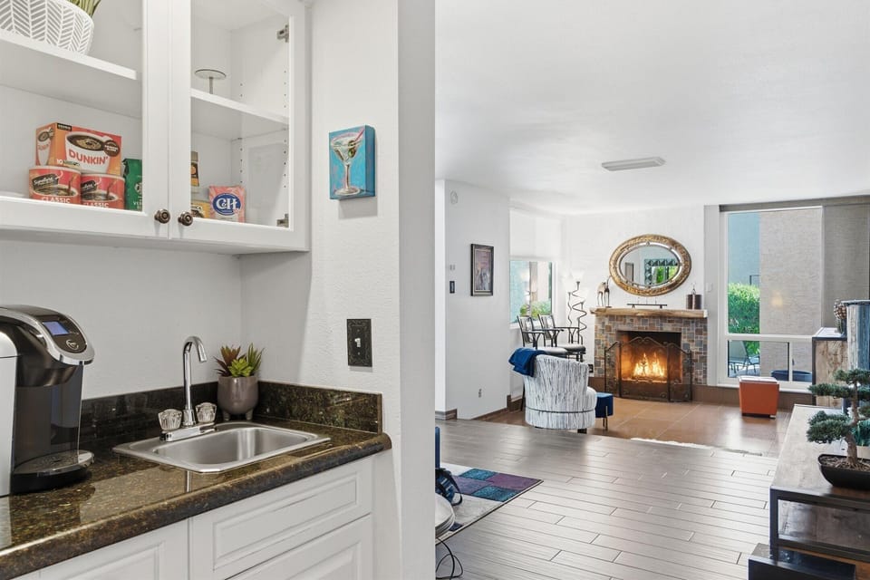 Wet bar with a sink and coffee maker.