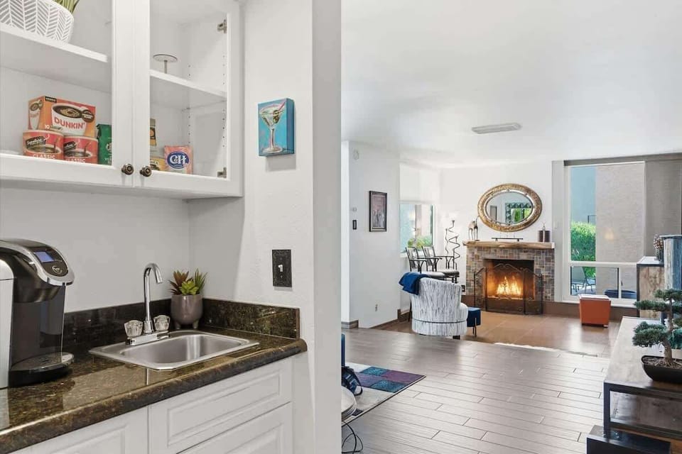 Wet bar with a sink and coffee maker.