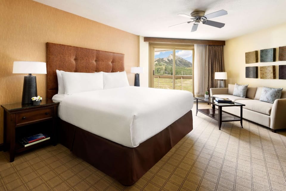 King bed with large window and mountain scenery