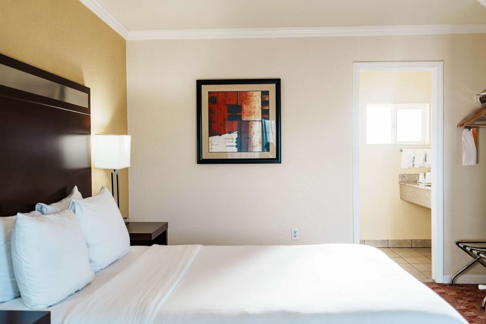 Comfortable bed with view into bathroom area