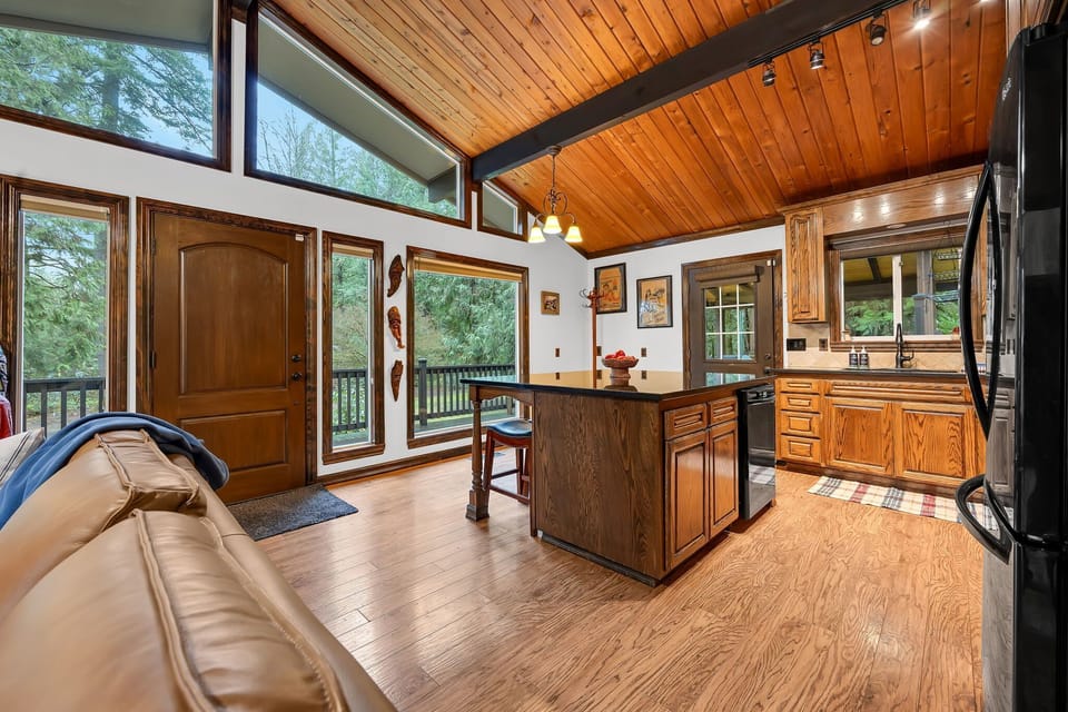 Inviting kitchen and entry area with island seating and easy indoor-outdoor living.