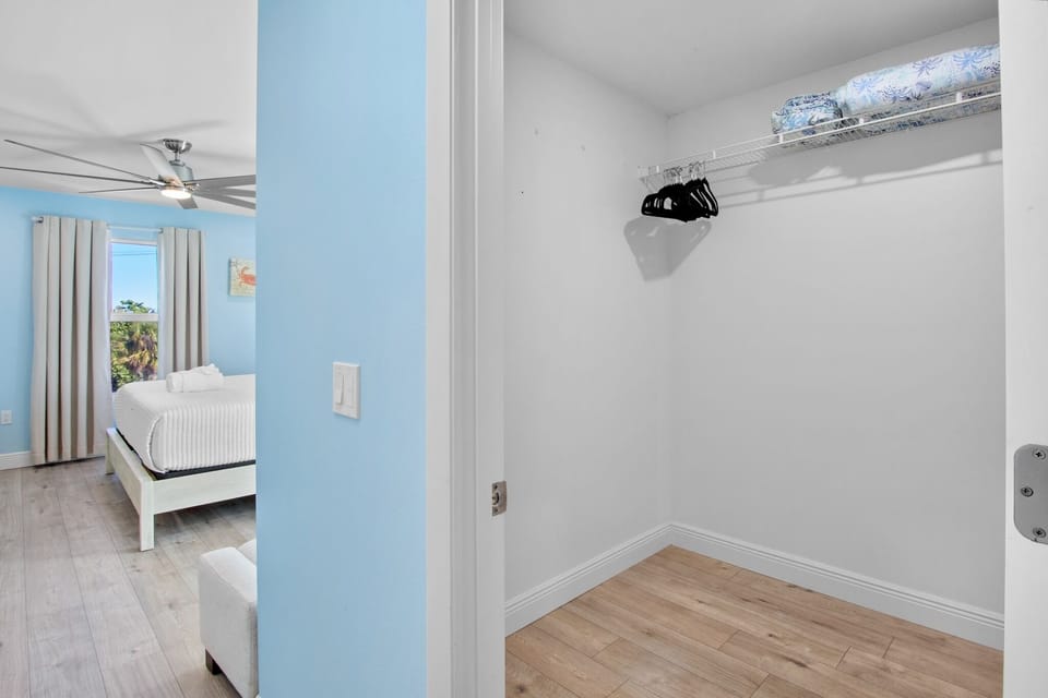 Your spacious walk-in closet offers plenty of room to unpack and organize your vacation wardrobe with built-in shelving and hanging space.