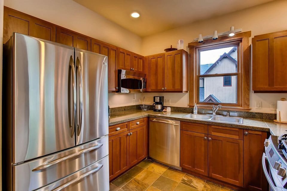 This well-equipped kitchen showcases sleek stainless steel appliances and ample cabinet space, making it perfect for culinary adventures.