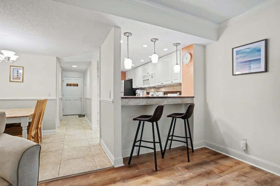 Your open-concept space flows beautifully from kitchen to living area, with a breakfast bar perfect for morning coffee and casual meals.