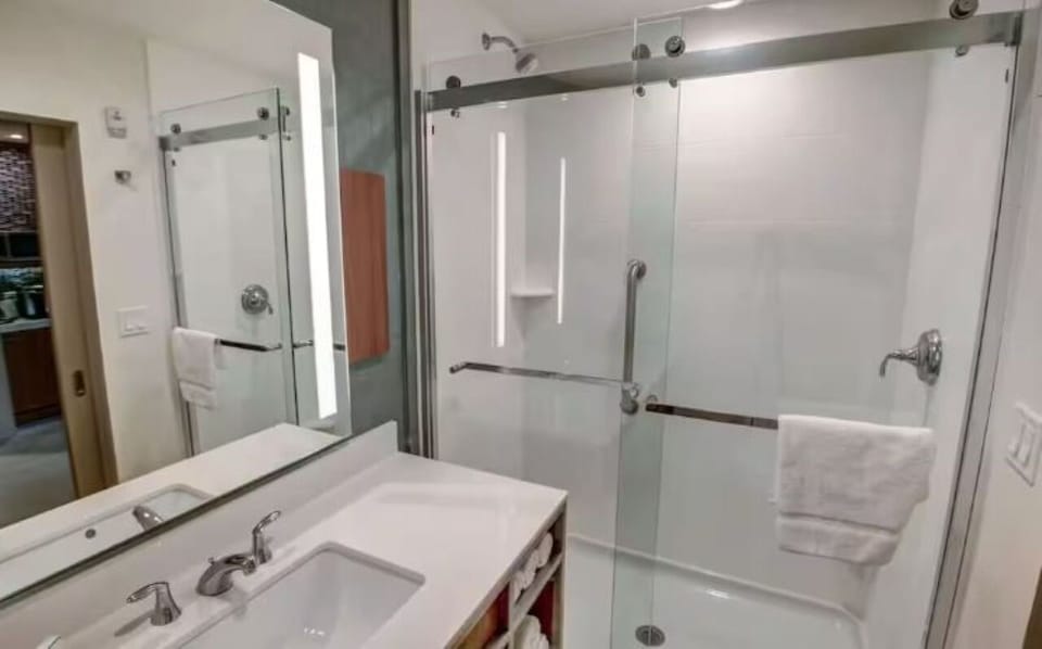 Refresh in a sleek glass shower with bright, clean finishes.