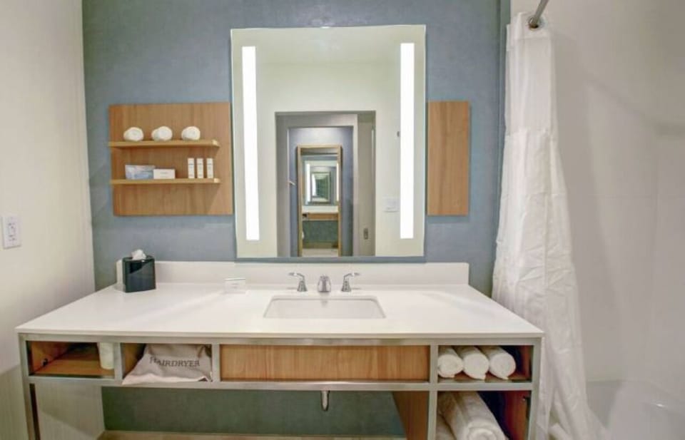 Get ready with a glowing mirror and neatly stocked towels.