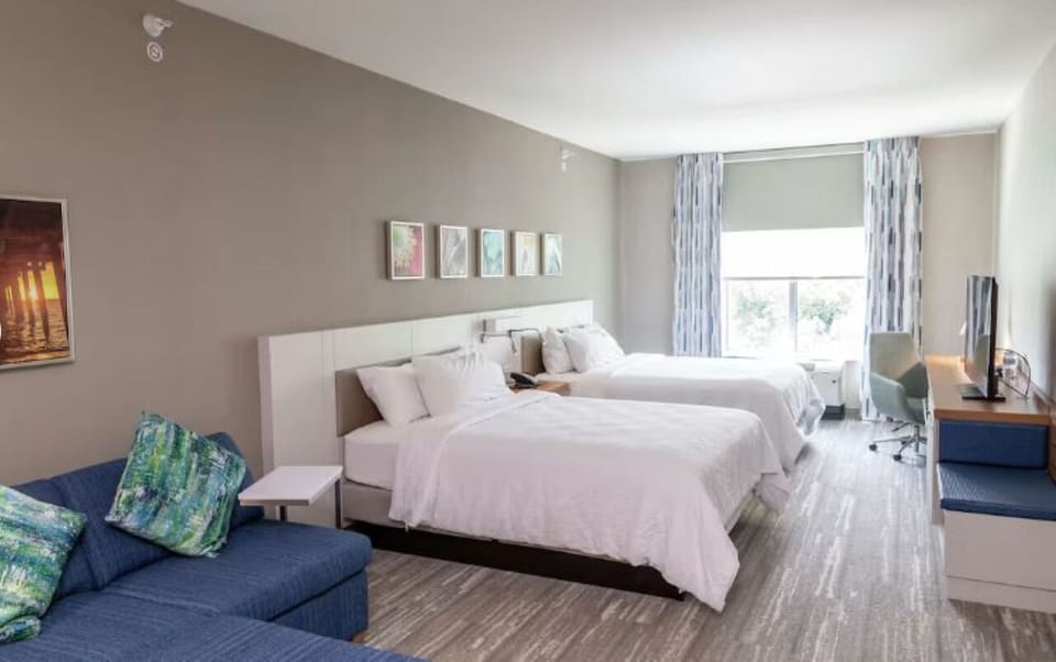 Settle in with roomy beds, soft linens, and calming tones.