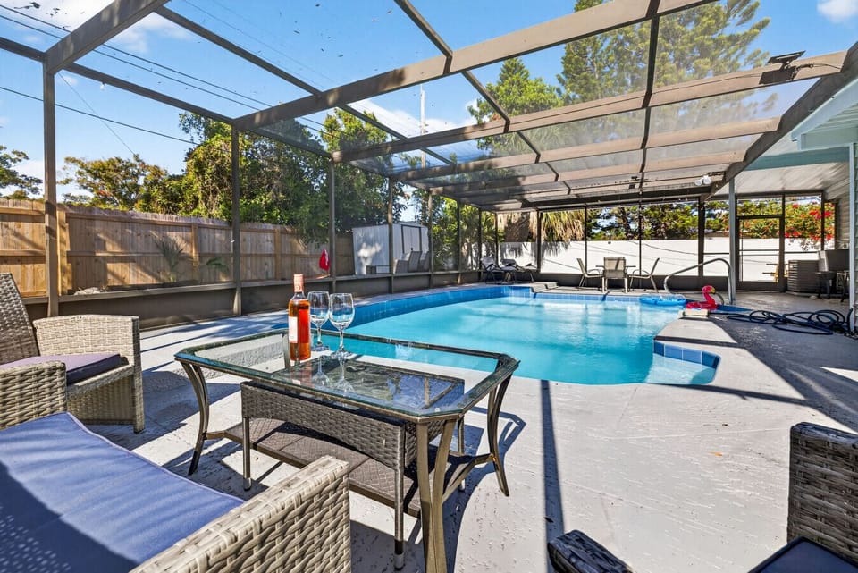Relax poolside with comfortable seating in the covered lanai