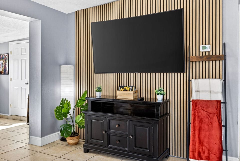 Open-concept living room with a large screened TV