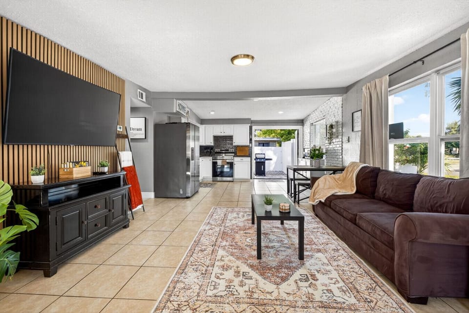 Open-concept living room with a large screened TV