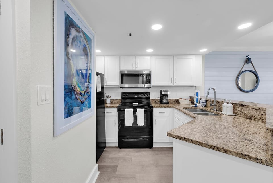 Fully equipped kitchen with granite counters. Open concept—perfect for mornings!