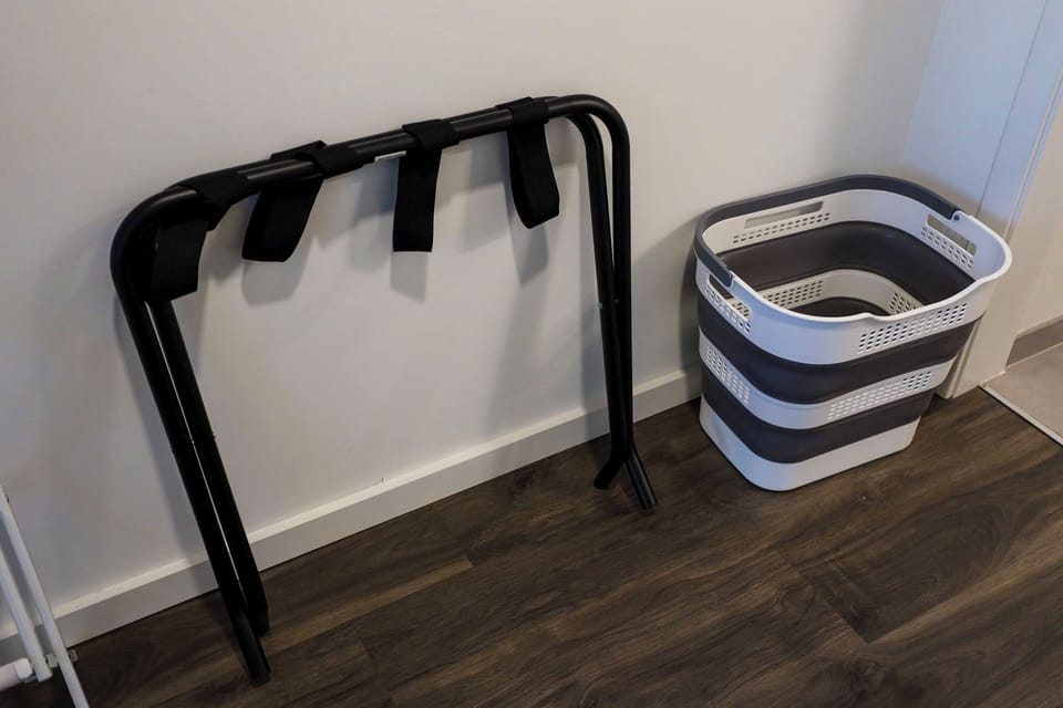 Luxe bedroom walkthrough closet with waste basket