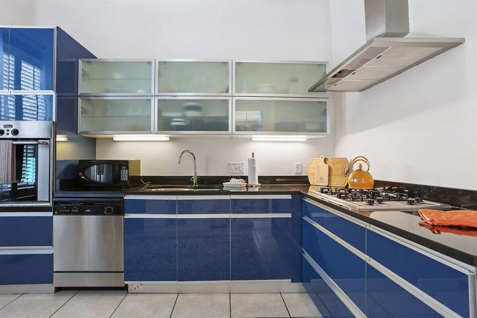 Modern kitchen with tall ceilings, sleek cabinetry, and plenty of space for cooking and gathering.
