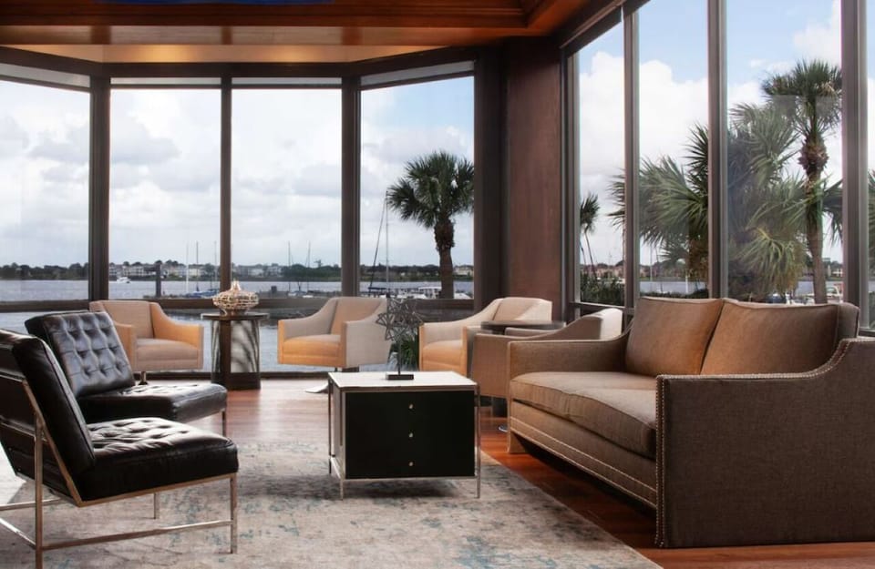 Unwind in sunlit lounge seating with calming waterfront views.