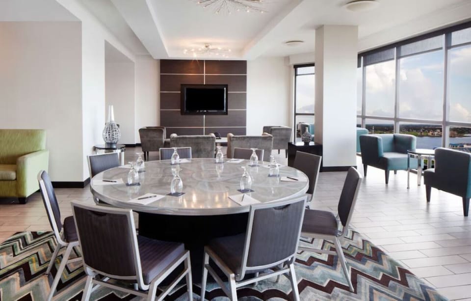 Gather in a chic lounge with panoramic bayfront windows.