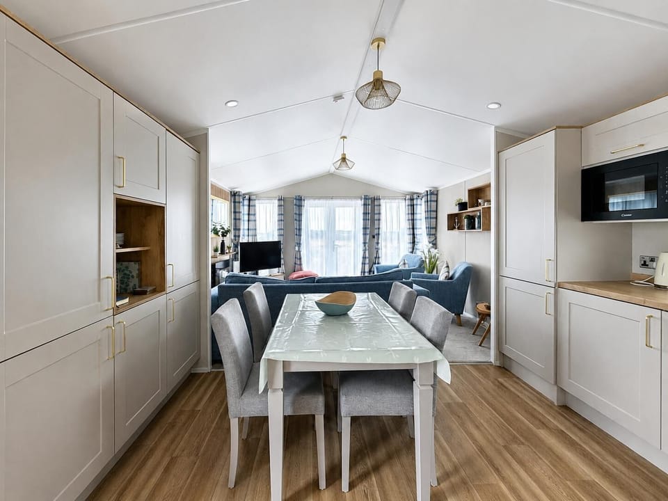 With an open plan dining room and living room, everyone can join in the conversation on a family holiday in this 6 berth caravan.