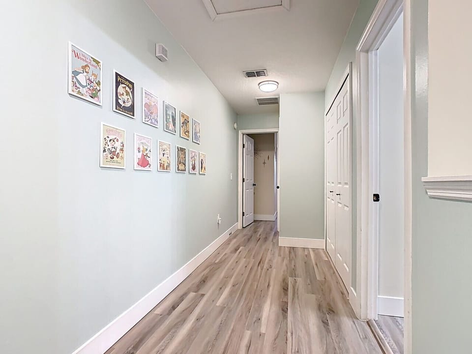 Bright hallway with artwork, and smooth flow throughout the home.