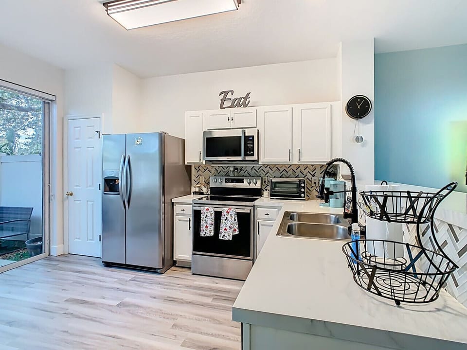 Bright, fully equipped kitchen featuring stainless steel appliances, ample counter space, and modern finishes for easy meal prep.