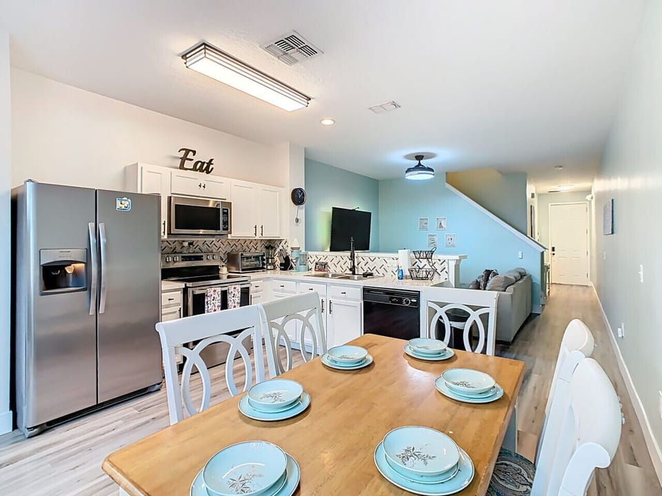 Bright dining area with open kitchen, perfect for shared meals.