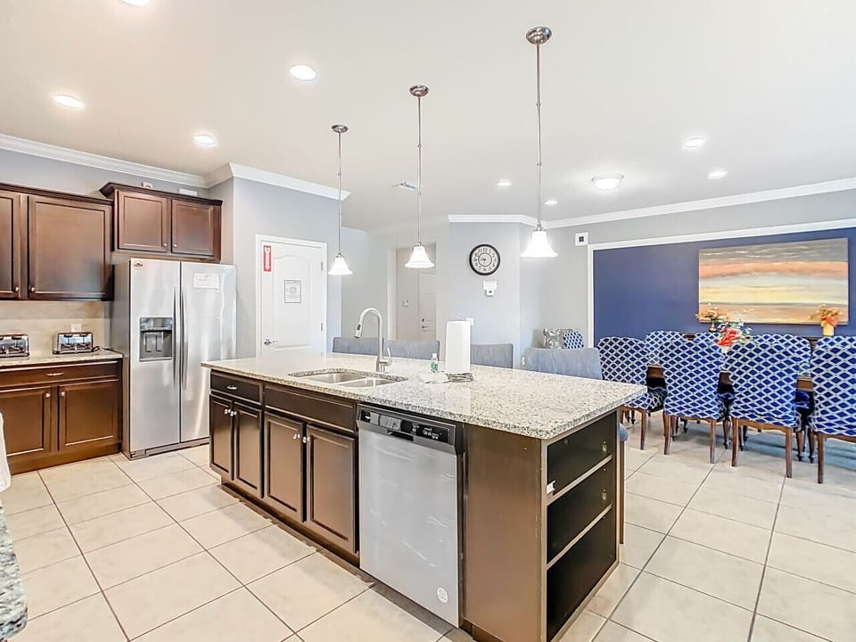 Granite island serves as the centerpiece of the kitchen