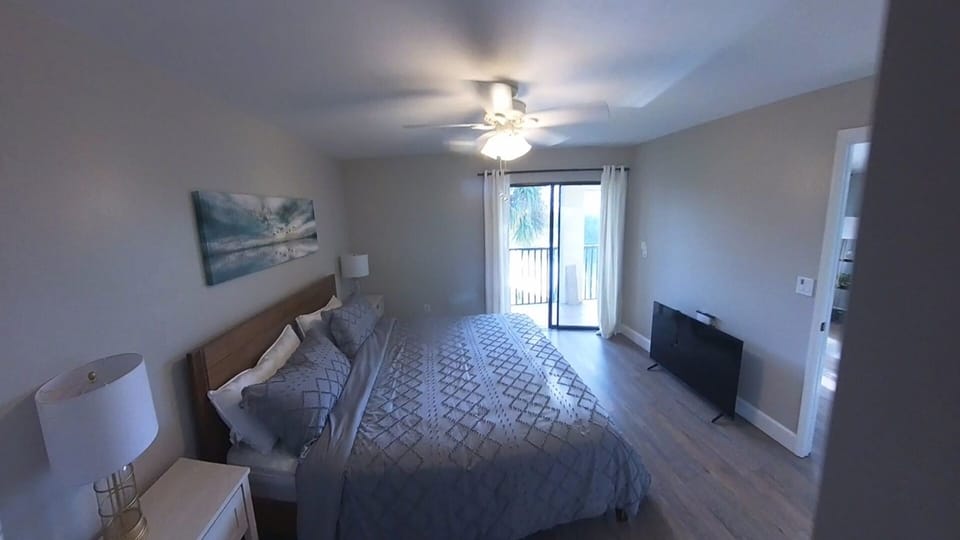 Master bedroom with private balcony entrance and golf course view