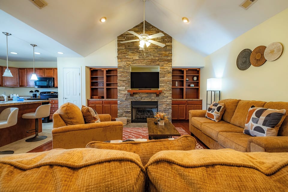 Gather around and make memories! The open-concept living area features a stunning stone fireplace, comfortable, plush seating, and a large Smart TV for movie nights after exploring the Smokies.