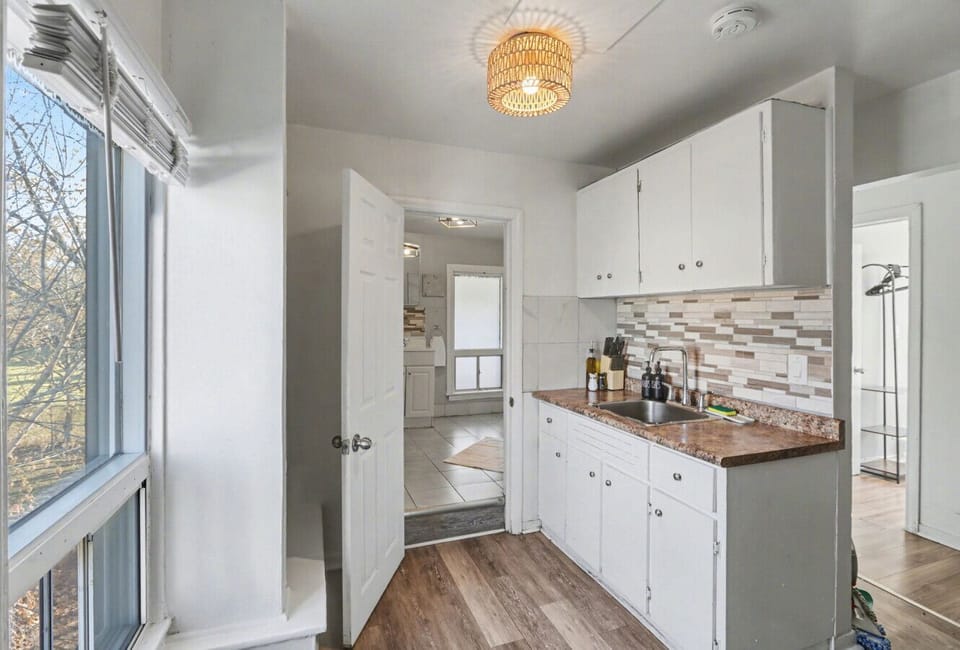 Prepare a delicious meal in this tidy kitchen featuring a full stove and modern tiled backsplash. A bright, inviting space that offers everything you need to feel right at home during your stay.