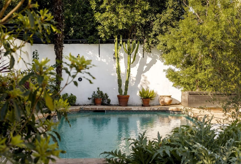 Take a refreshing dip in our sparkling pool, surrounded by lush greenery for a serene escape.