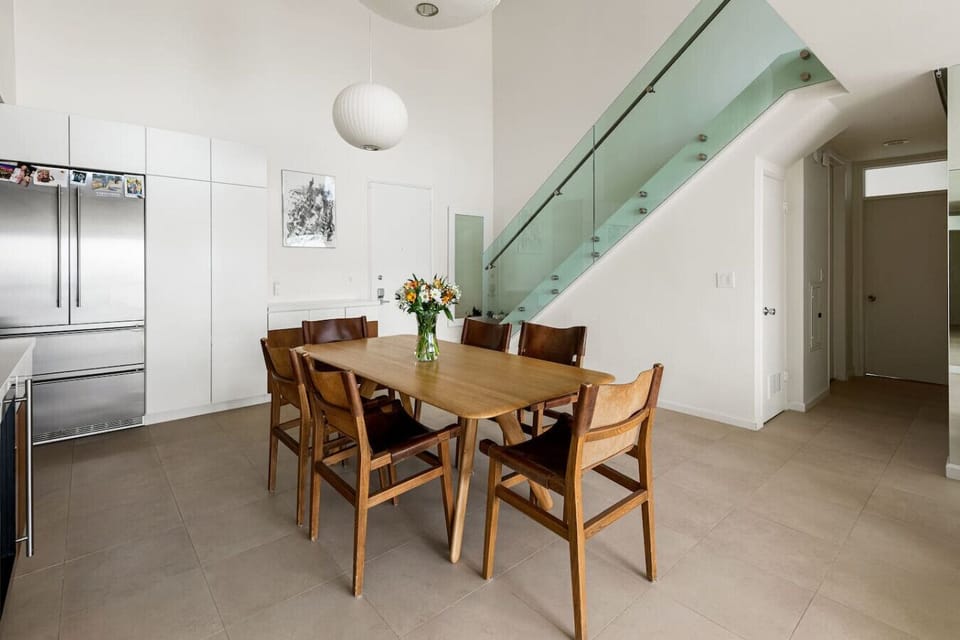An elegant 6-seater dining space with natural light and a clean, modern aesthetic, ideal for dining together and creating lasting memories.