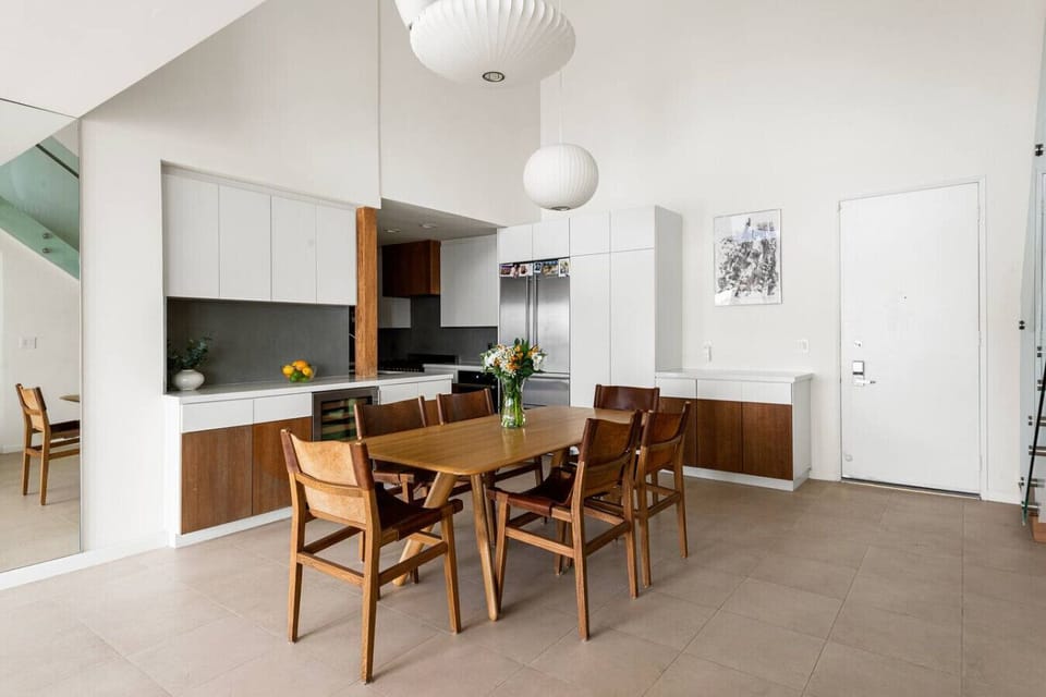 An elegant 6-seater dining space with natural light and a clean, modern aesthetic, ideal for dining together and creating lasting memories.