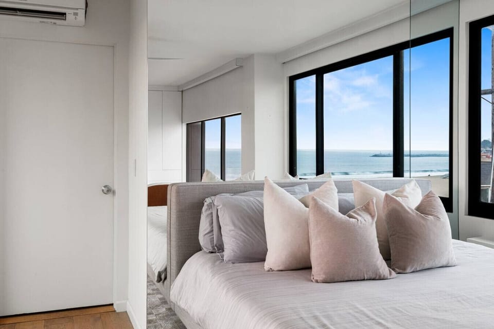 Enjoy a serene escape in these carefully designed bedrooms with breathtaking ocean views, flooded with natural light and featuring modern, comfortable furnishings.