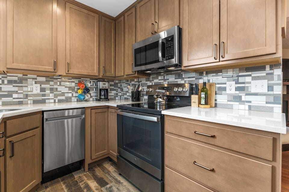 Quartz Countertops, Mosaic Tile Backsplash, Warm Wood Cabinetry