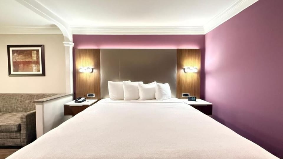 Drift off peacefully beneath warm lighting and cushioned headboard.