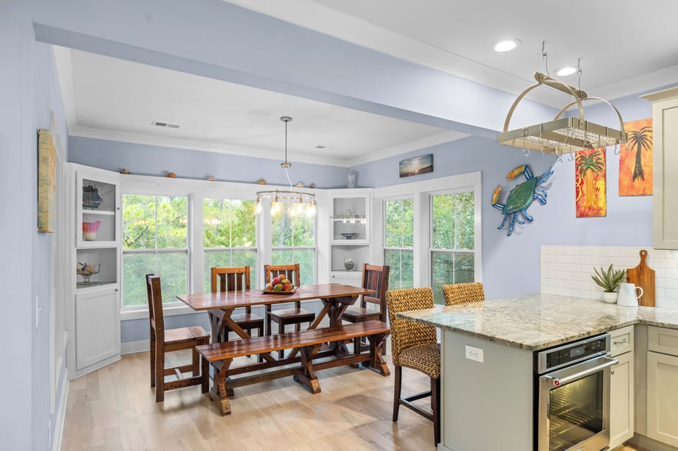 Dining area with a large wooden table and views.