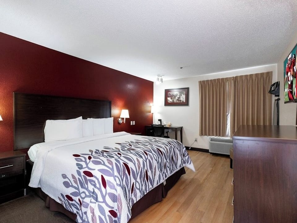 Unwind in crisp linens beside warm lighting and calm tones.