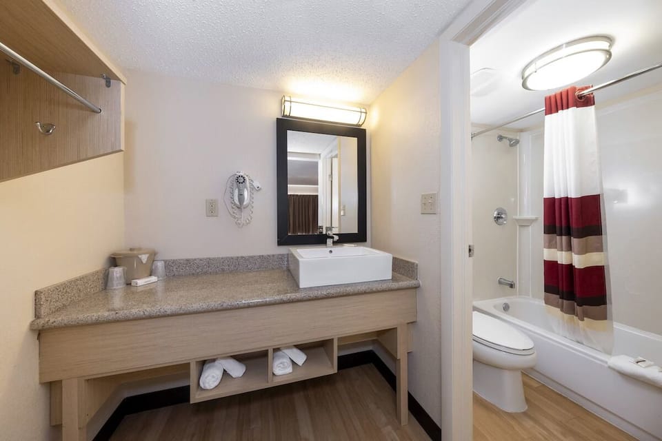 Refresh under bright lights with a spotless vanity and tub.