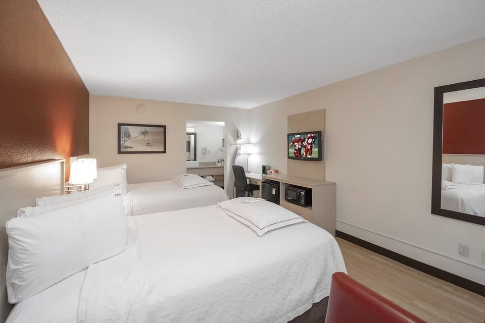 Unwind in crisp linens with TV and easy workspace.