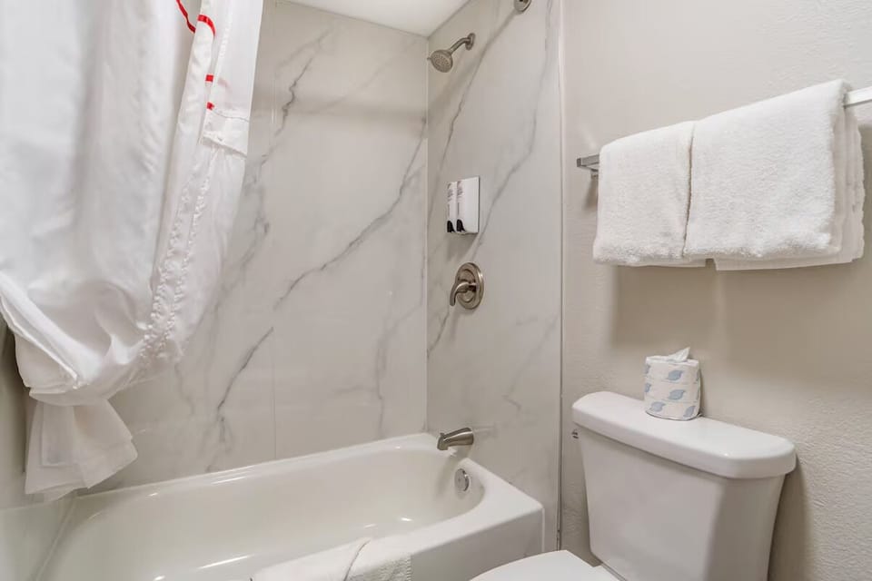 Refresh with a sparkling tub-shower and fluffy white towels.